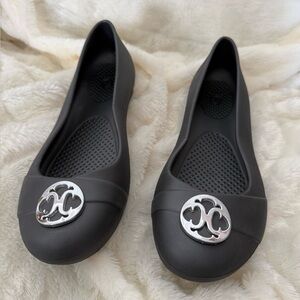 Black Women's Slip-On Ballet Flats with Silver Emblem